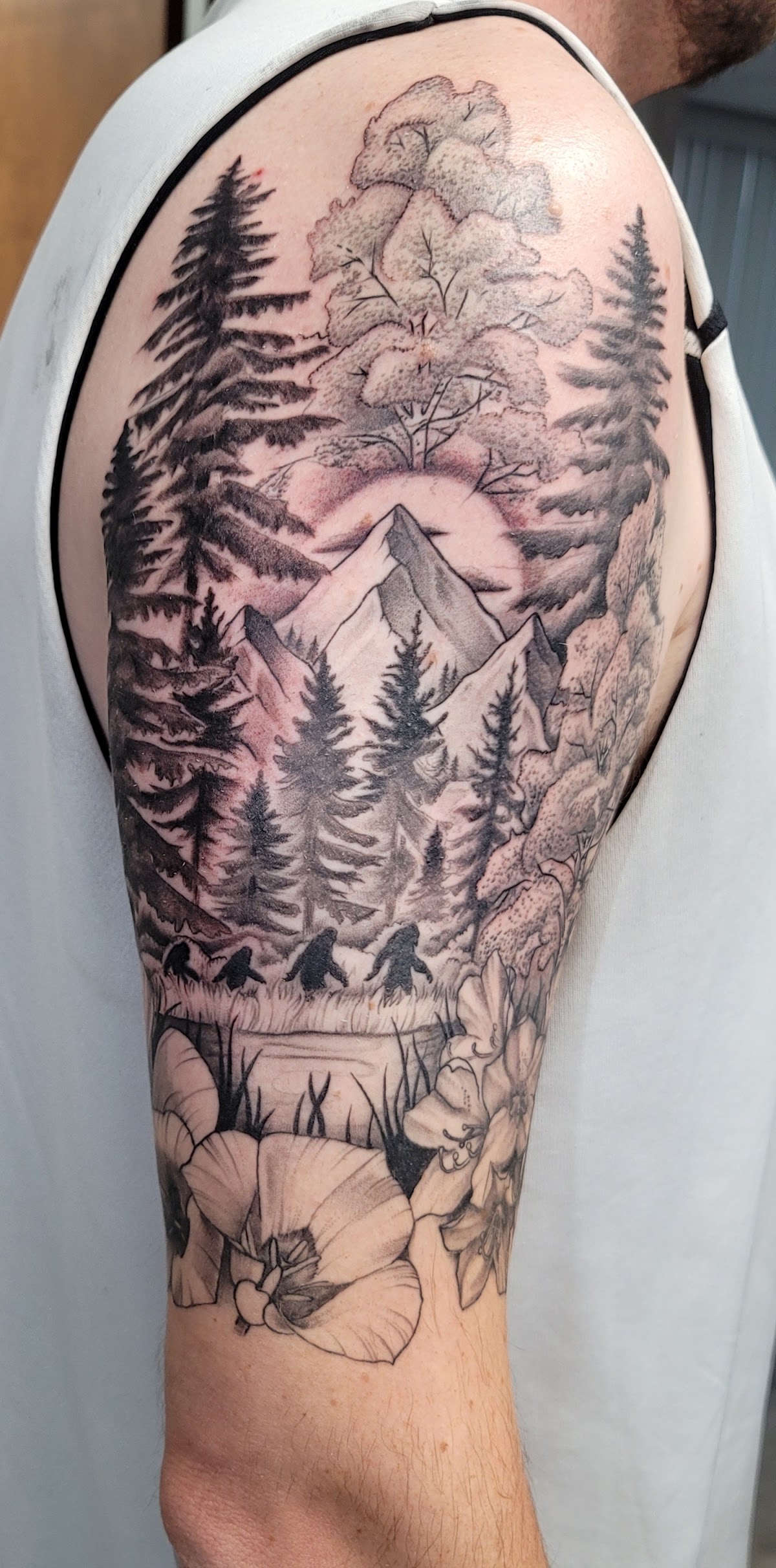 Black and grey forest and mountain sleeve tattoo by Eddie at Magnetic Ink